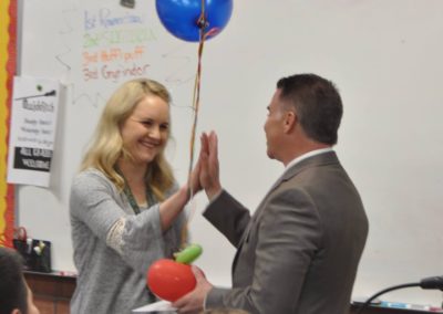 Giving out Teacher of the Year Awards in the classroom